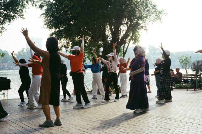 People exercising outdoors by a lake