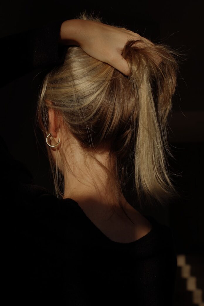 Photo by Polly Alexandra a woman with her hair in a bun