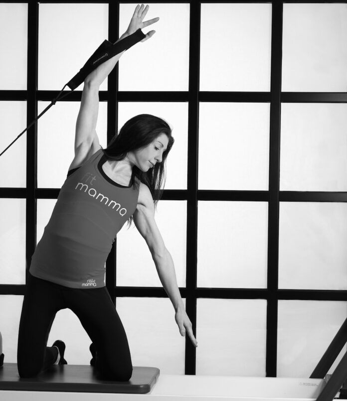 Photo by Helen Thomas woman in white tank top and black leggings doing yoga
