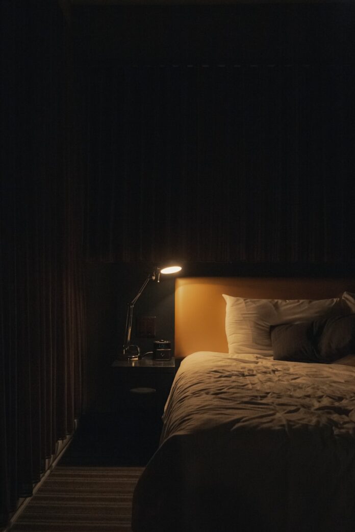 Photo by Jp Valery turned on study lamp beside bed